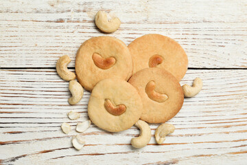 Tasty cashew cookies on rustic wooden table, flat lay