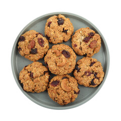 Delicious oatmeal cookies with dried cranberries and nuts isolated on white, top view