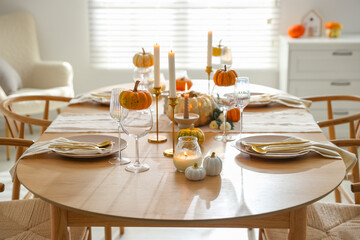 Stylish dining room with beautiful table setting and autumn decor