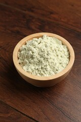 Dry wasabi powder in bowl on wooden table
