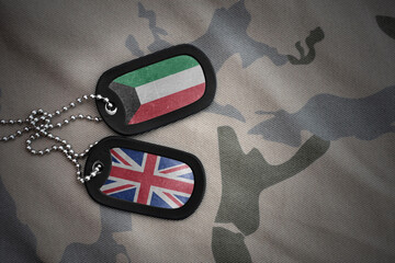 army blank, dog tag with national flag of kuwait and great britain on the khaki texture background. military concept.