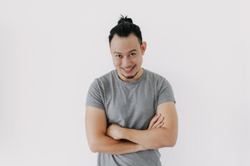 Good recommended pose of smile Asian man in grey t-shirt isolate on white.