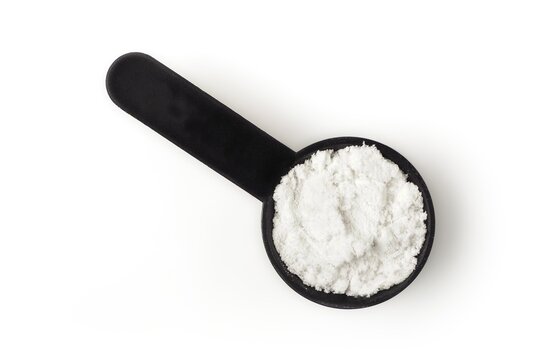 Scoop with creatine protein for sporty lifestyle. High angle view isolated on white.