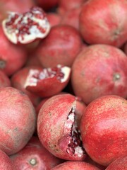 ripe pomegranates, whole and broken, on the counter
