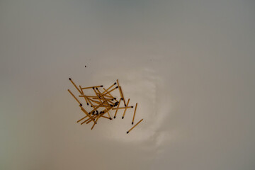 Wooden matches are scattered on a white background.