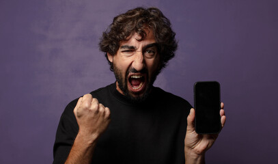 young bearded crazy man with a smartphone