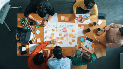 Top down aerial view of business team making scrum task board at meeting room. Group of people...