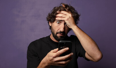 young bearded crazy man with a smartphone