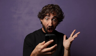 young bearded crazy man with a smartphone