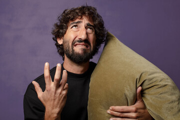 young bearded crazy man hugging a cushion