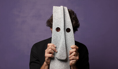 young bearded crazy man with an african mask
