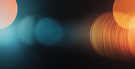 Abstract bokeh lights in teal and amber hues. Dark background.