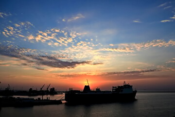 Obraz premium Sunset. Sunrise. Night views of ships and berths in the port. 2024.