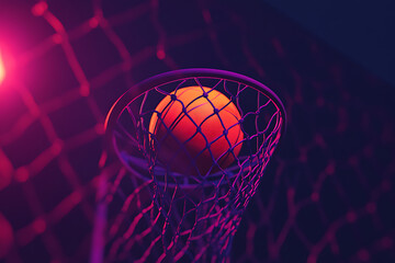 A vibrant basketball poised to enter a hoop, illuminated by colorful lighting.