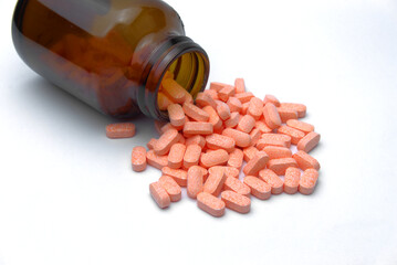 Open a bottle of vitamin C tablets spilled on the white floor Helps increase immunity against viruses