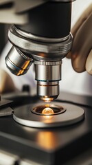 A close-up of a microscope focusing on a specimen, highlighting the intricate details of the instrument and the sample being examined.