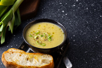 A bowl of leek soup with toasted bread