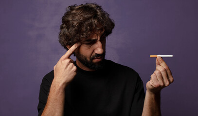 young bearded crazy man with a cigarette