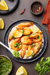  Fried shrimps with lemon and green in a plate vertical photo