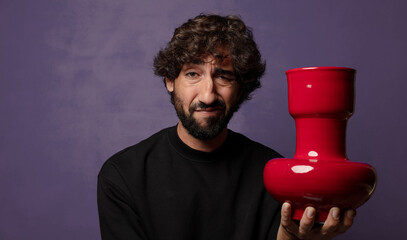 young bearded crazy man with an empty flower pot