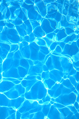 blue and light blue tones of swimming pool water with light reflections ideal as a neutral background for vacation