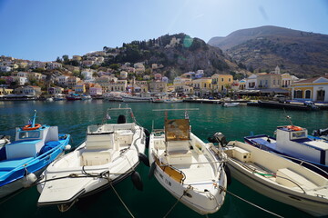 Obraz premium boats in the picturesque and beautiful waters of Symi island marina