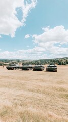 Several M48 Patton tanks are arranged in a striking line across a sunny meadow, surrounded by green hills and fluffy clouds, suggesting military readiness and historical significance