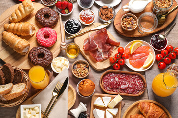 Different tasty food served for brunch on wooden table, flat lay