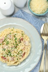 Delicious pasta Carbonara with bacon served on table, flat lay