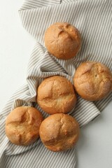 Homemade tasty buns on light table, top view