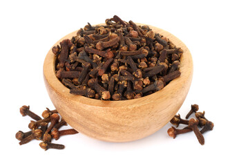 Dry clove buds in wooden bowl on white background. Aromatic spice