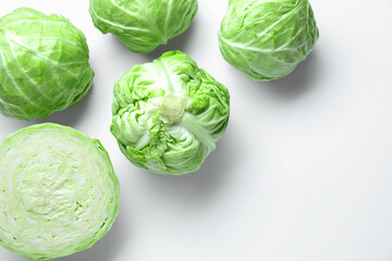 Fototapeta premium Raw green cabbages on white background, flat lay. Space for text