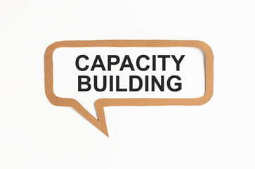 Lettering Capacity Building, in a frame on a white background