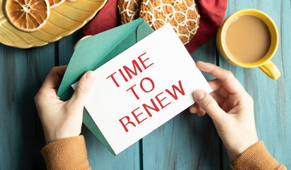 Notepad with the text Time to Renew on a light background, near glasses and stationery.