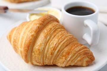 Tasty fresh croissant served on white table, closeup