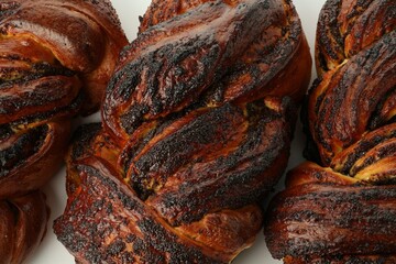 Tasty buns with poppy seeds on table, closeup