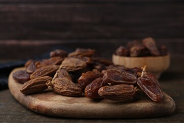 Tasty dried dates on wooden table, closeup