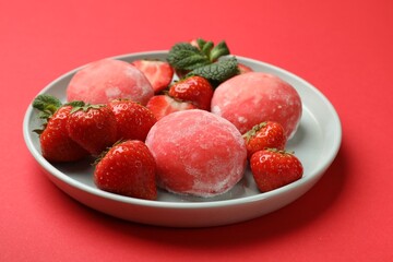 Delicious mochi, strawberries and mint on red background, closeup