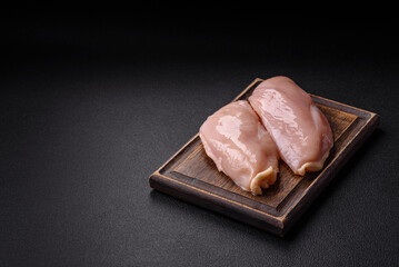 Pieces of raw chicken or turkey fillet with salt, spices and herbs