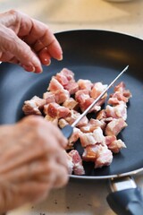 Close-up of bacon during the preparation, cutting and cooking process