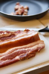 Close-up of bacon during the preparation, cutting and cooking process