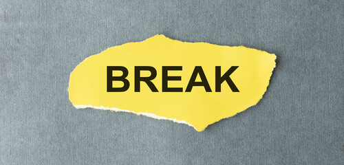 Break text, Inspiration, Motivation and business concept on yellow torn paper.