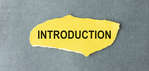 The text Introduction appearing behind torn brown paper.