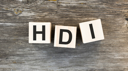 HDI text on wooden block on wooden background