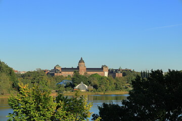 Naklejka premium Swedish nature in early autumn one sunny day. Swedish building called naturhistoriska riksmuseet. Translated in english to the National Museum of Natural History.