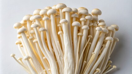 Fresh enokitake mushrooms arranged on a surface