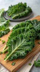 Fresh Kale Leaves on Wooden Cutting Board with Green Background