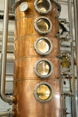 Distillate production process in copper distillation unit. Cpper vacuum still for distillation performed under reduced pressure for gin production.
