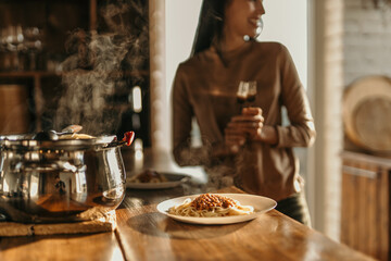 Couple cooking together in a bright kitchen, smiling as they prepare fresh pasta with sunlight streaming in