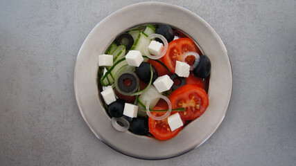 Greek salad with pixel tomatoes, cucumbers, salamoya olives, feta cheese, white onion, olive oil....